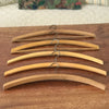 Lot de 6 cintres anciens arrondis en bois par Hello Broc brocante en ligne