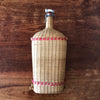 Grande bouteille décorative de 2,5 litres dans son écrin en rotin tressé Lourdes par Hello Broc brocante en ligne