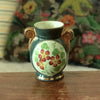 Petit vase en céramique verte avec un bouquet de fleurs en médaillon Enghien France