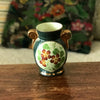 Petit vase en céramique verte avec un bouquet de fleurs en médaillon Enghien France
