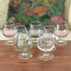 Ensemble de 7 verres à cognac vintage sur pied en verre moulé multicolores dans les tons pastels de 13 cl par Hello Broc brocante en ligne