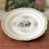 Plat de service rond vintage attribution porcelaine du Berry décor central calèche et volutes dorés diamètre de 31 cm par Hello Broc brocante en ligne