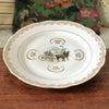 Plat de service rond vintage attribution porcelaine du Berry décor central calèche et volutes dorés par Hello Broc brocante en ligne
