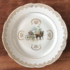Plat de service rond vintage attribution porcelaine du Berry décor central calèche et volutes dorés par Hello Broc brocante en ligne