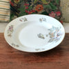 Grand plat rond légèrement creux en porcelaine de Limoges ULIM décor pavots diamètre de 31 cm par Hello Broc brocante en ligne