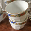 Service à café vintage en porcelaine Victoria China Czechoslovakia décor frise florale multicolore sur fond bleu par Hello Broc brocante en ligne
