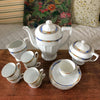 Service à café vintage en porcelaine Victoria China Czechoslovakia décor frise florale multicolore sur fond bleu par Hello Broc brocante en ligne