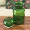 Ancien bocal à café vintage en verre moulé vert et frises imprimées dorées par Hello Broc brocante en ligne
