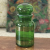 Ancien bocal à café vintage en verre moulé vert et frises imprimées dorées par Hello Broc brocante en ligne
