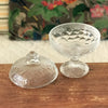 Sucrier bonbonnière sur pied en verre moulé incolore décor fruits et feuillages par Hello Broc brocante en ligne