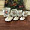 Ensemble de 4 pots à épices en faïence fine et décor fleurs multicolores Circa 1930 par Hello Broc brocante en ligne