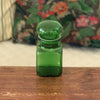 Petit bocal publicitaire Ariel en verre moulé vert années 60 par Hello Broc brocante en ligne