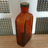 Grand flacon de médicament ancien en verre moulé ambré des Laboratoires J.L. Châtelain par Hello Broc brocante en ligne