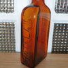 Grand flacon de médicament ancien en verre moulé ambré des Laboratoires J.L. Châtelain par Hello Broc brocante en ligne