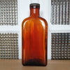 Grand flacon de médicament ancien en verre moulé ambré des Laboratoires J.L. Châtelain par Hello Broc brocante en ligne