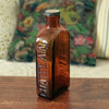 Grand flacon de médicament ancien en verre moulé ambré des Laboratoires J.L. Châtelain par Hello Broc brocante en ligne