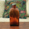 Grand flacon de médicament ancien en verre moulé ambré des Laboratoires J.L. Châtelain par Hello Broc brocante en ligne