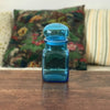 Petit bocal publicitaire Ariel en verre moulé bleu - Hello Broc